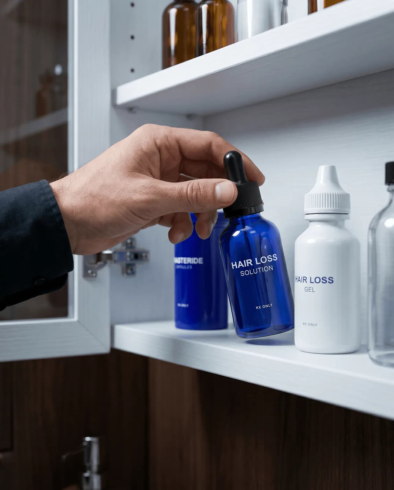 Hand reaching for a Hair Loss Solution dropper bottle in a medicine cabinet, beside Dutasteride Capsules and Hair Loss Gel