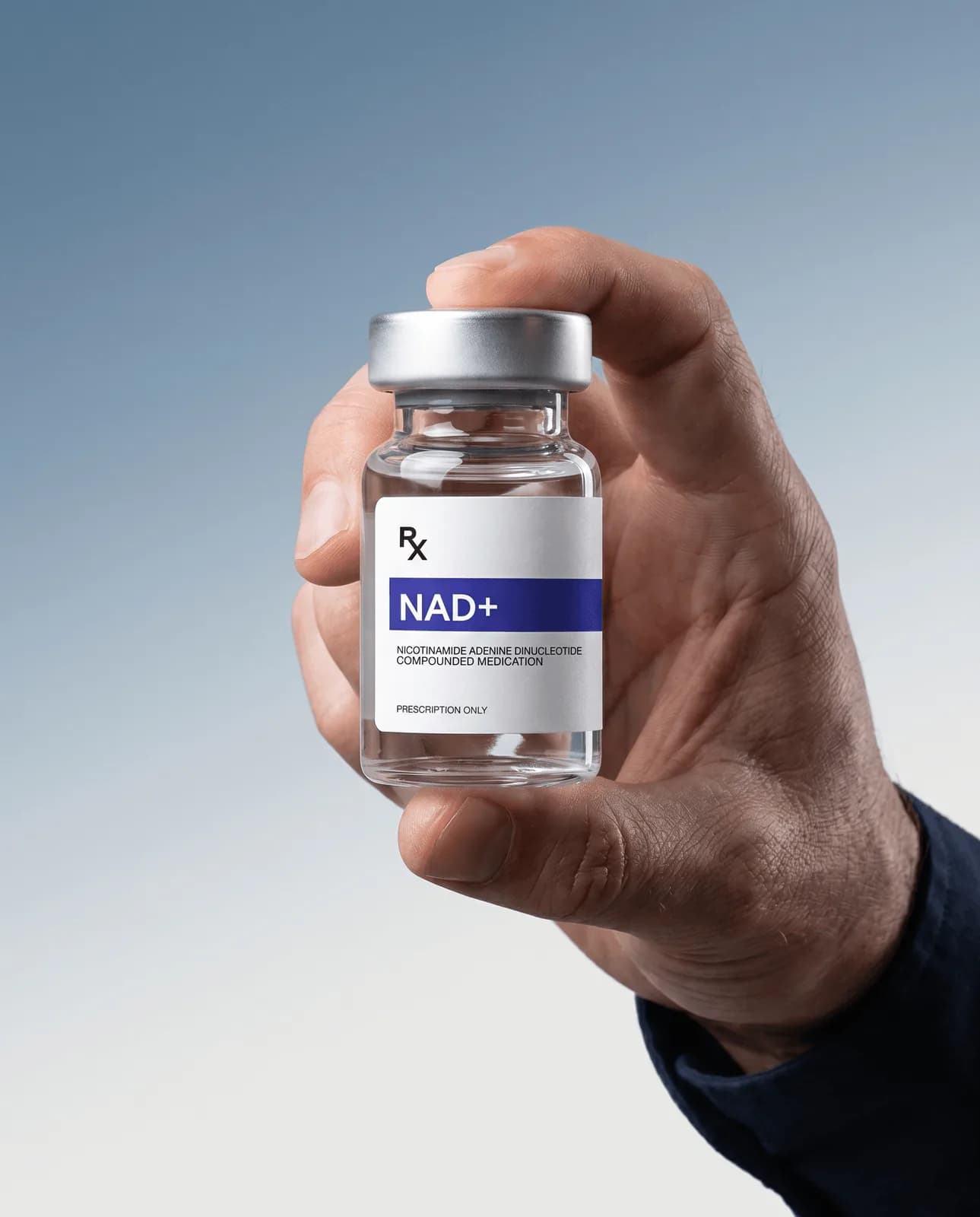 Hand holding a vial of compounded NAD+ Rx solution