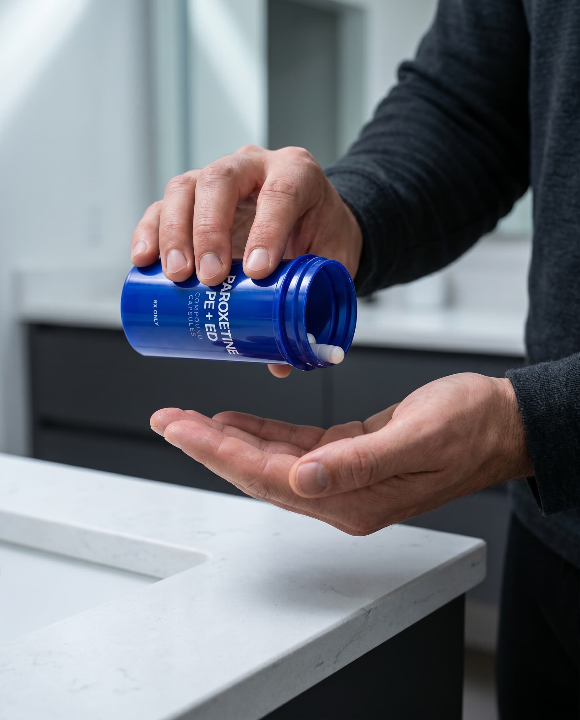 Man pouring ParoxetineRx PE + ED capsules from the bottle into his hand