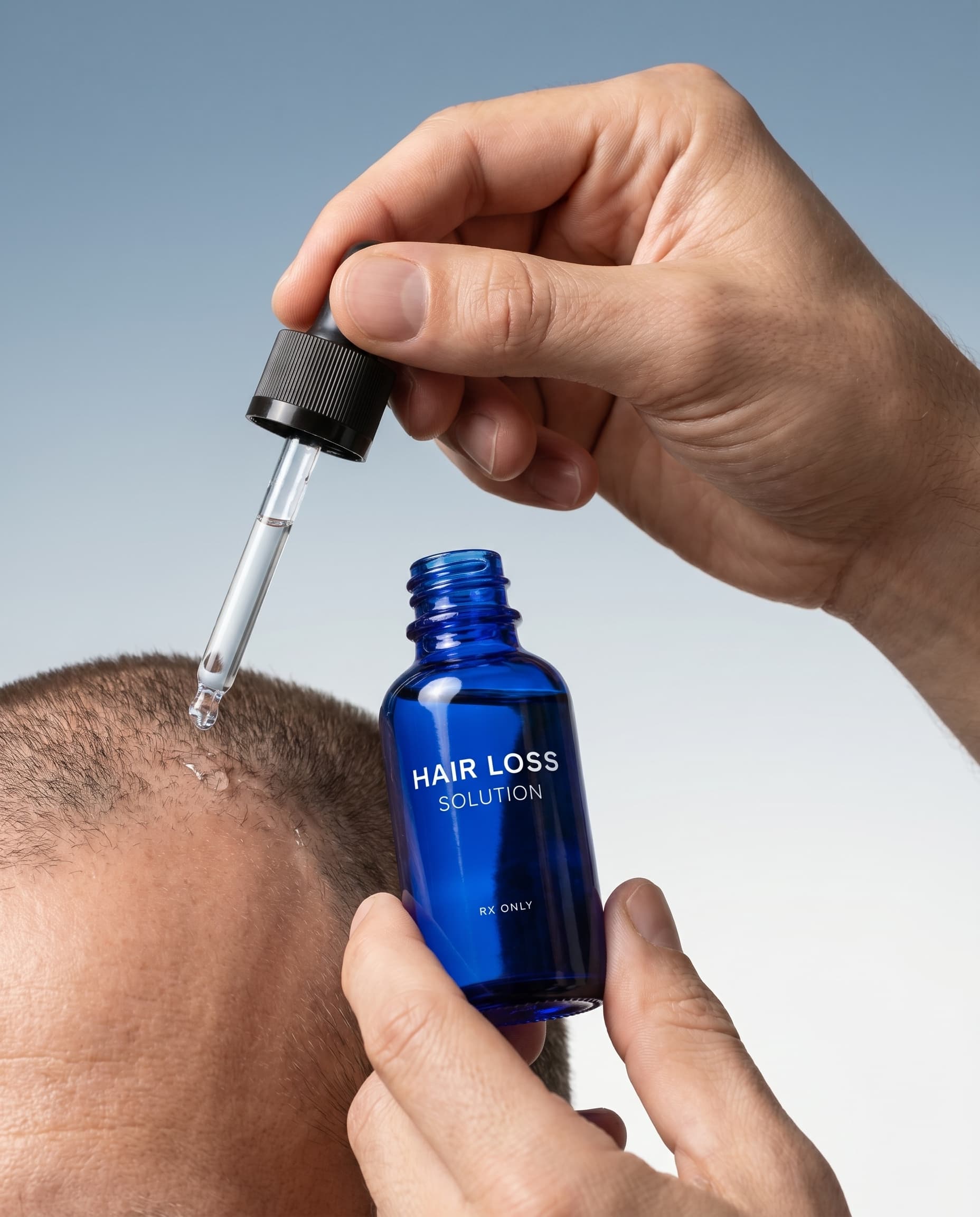 Hand applying Hair Loss Solution dropper directly to scalp