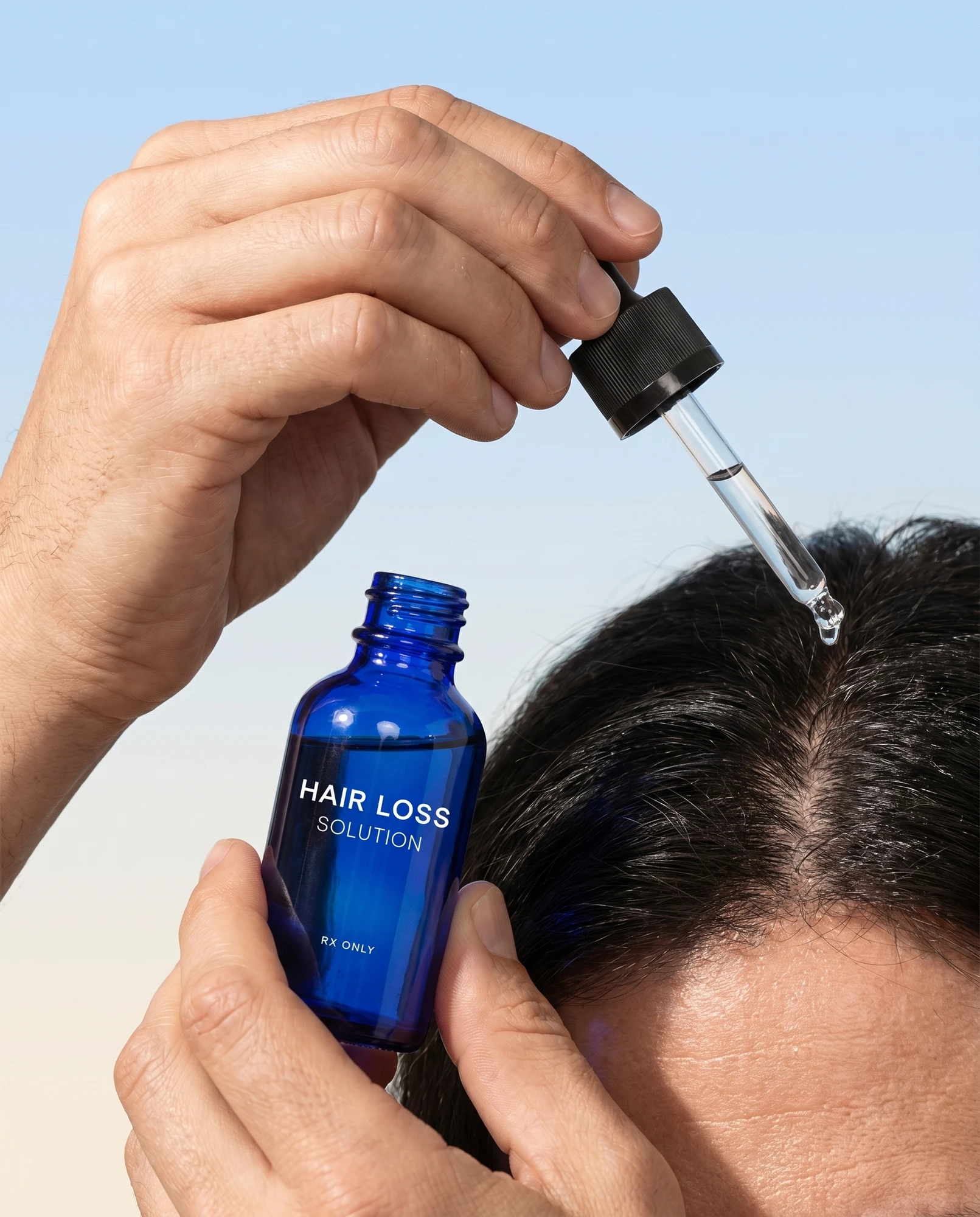 Dropper applying hair loss solution