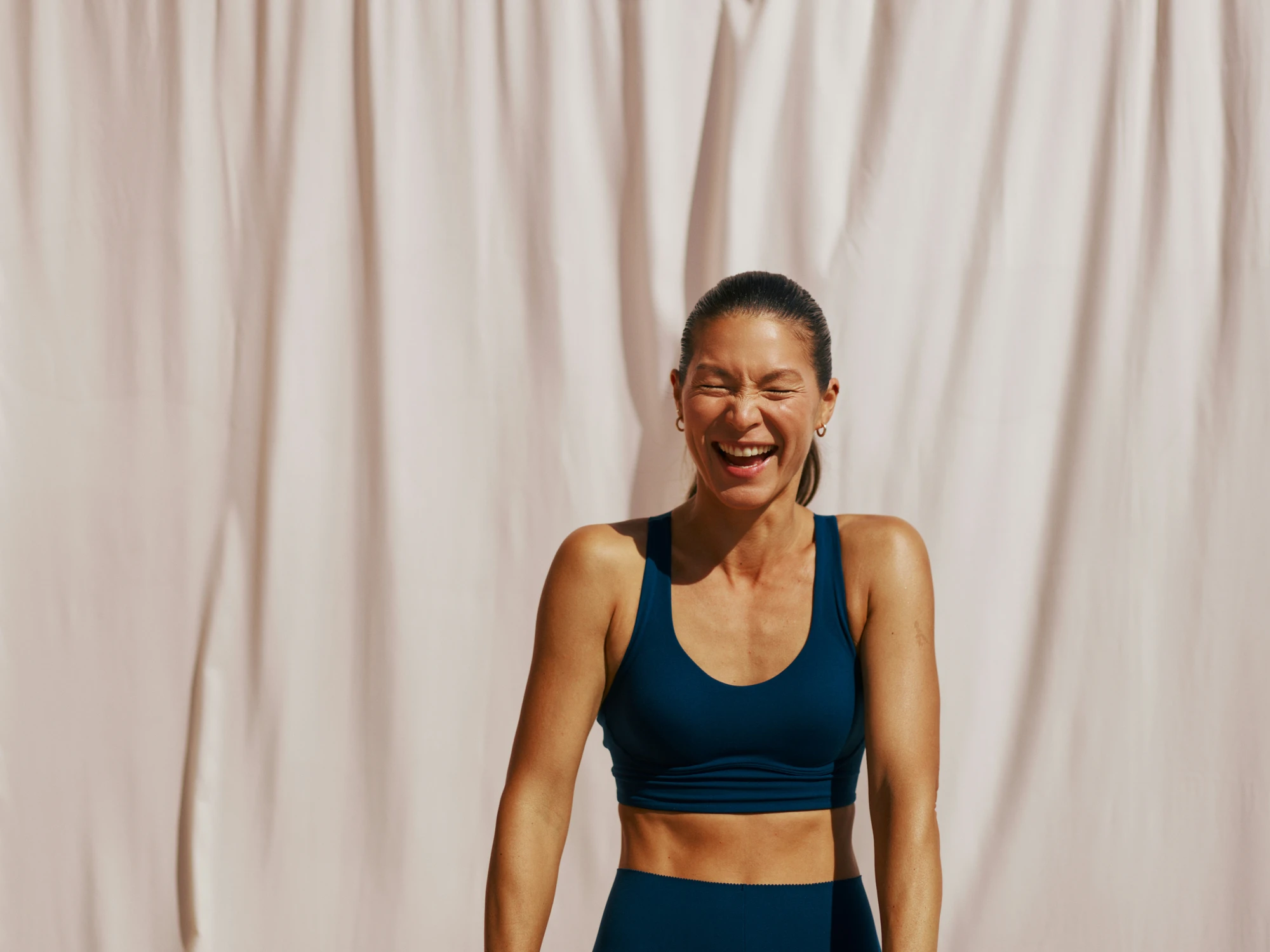 Woman laughing in athletic wear